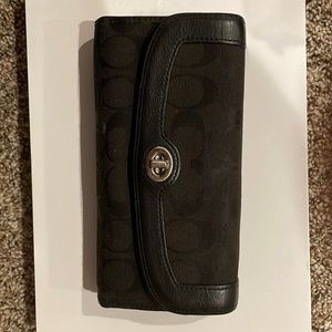 Used black Coach wallet.  Some wear but still definitely useable.